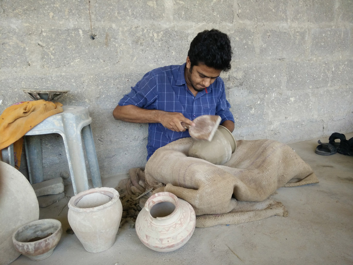 Bhargav shaping up a clay pot